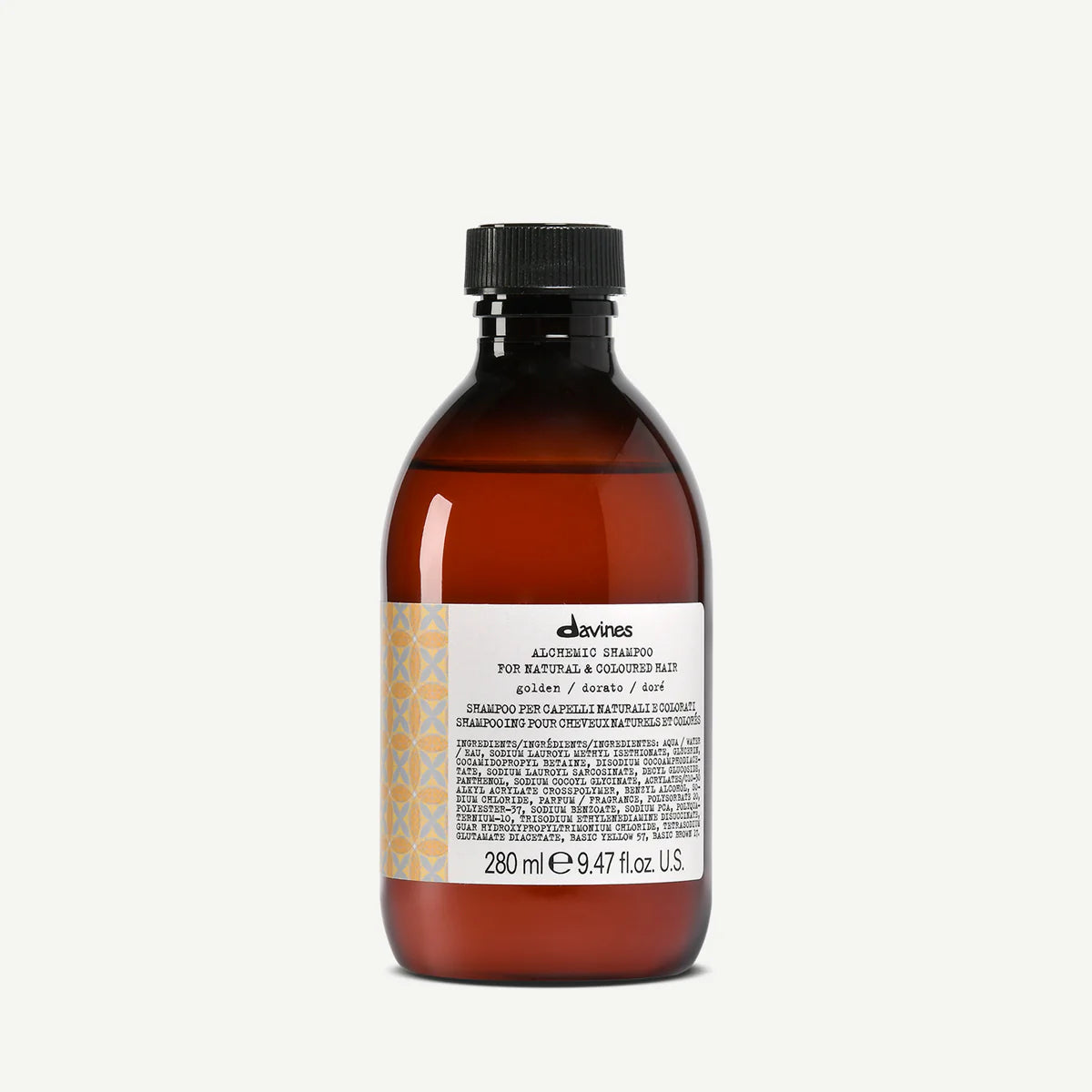 Flaska med Alchemic Shampoo Golden, ett schampo i en brun transparent flaska med svart skruvkork och etikett med text och mönster, perfekt för hårvård.