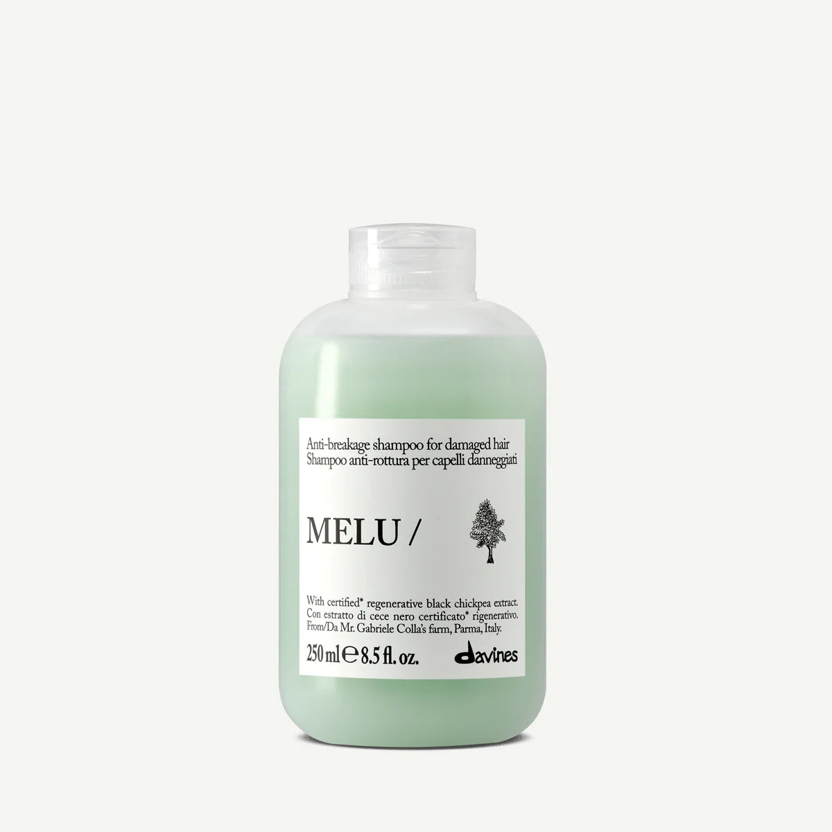 Flaska med Melu Anti-Breakage Shampoo, ett milt schampo för skadat hår i en grönaktig plastflaska med vit etikett och svart text.