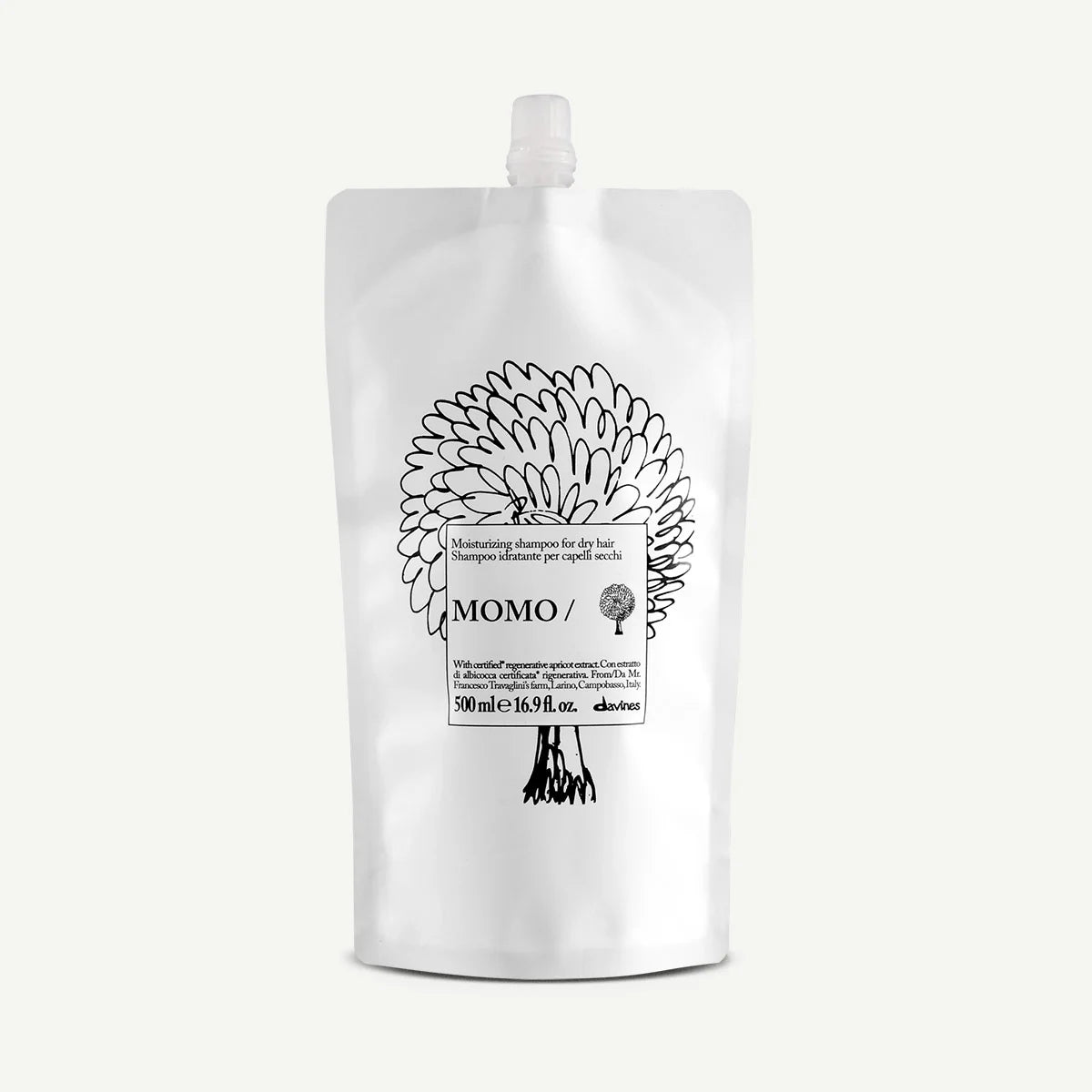 Momo Moisturizing Shampoo i en vit återfyllnadsförpackning med svart blomsterillustration, en miljövänlig schampon som återfuktar torrt hår.