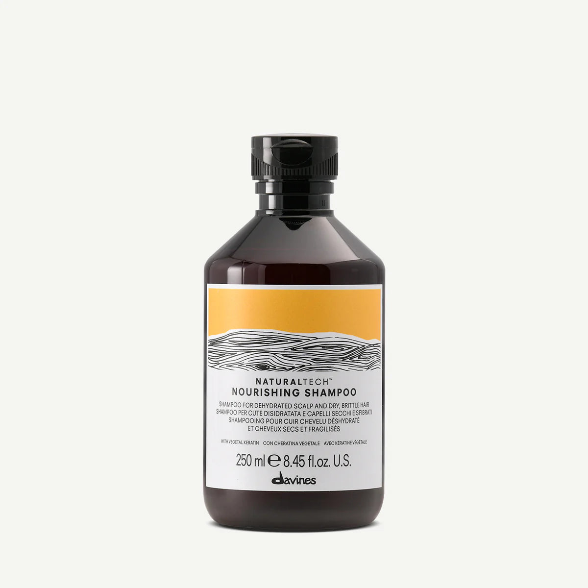 Flaska av Naturaltech Nourishing Shampoo framtagen för att vårda torr och känslig hårbotten med en skonsam och närande formula.