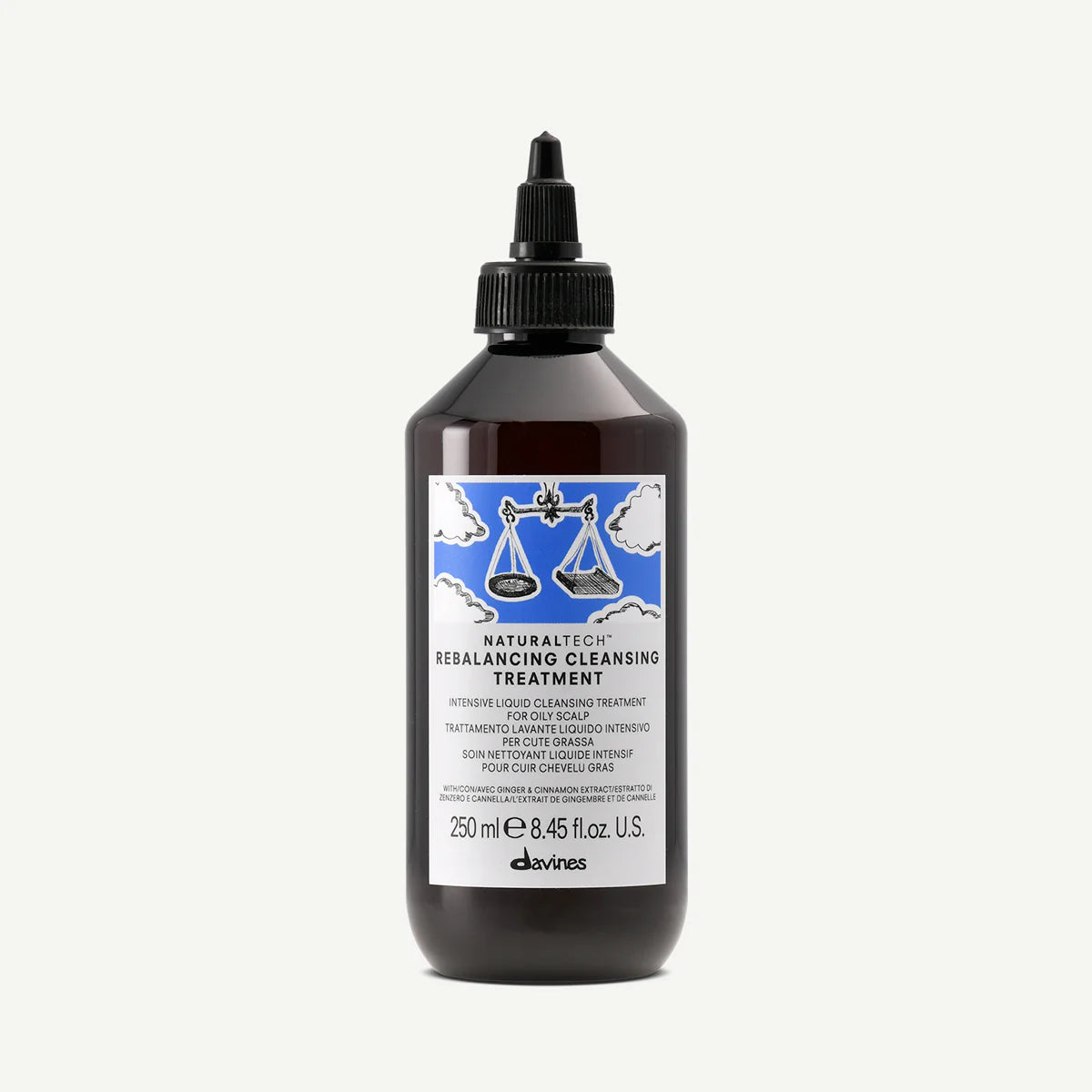 Brun flaska med Naturaltech Rebalancing Cleansing Treatment, en intensiv flytande rengöringsbehandling för hår, med en etikett som visar en våg mot en blå himmel.